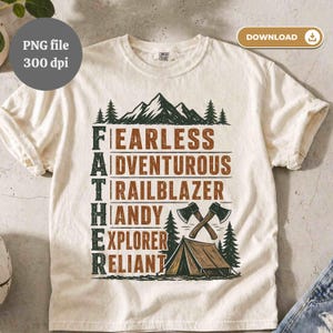 May include: Cream-colored t-shirt with a graphic design featuring the word "FATHER" with descriptive words like "FEARLESS" and "ADVENTUROUS". The design includes mountain and forest illustrations, axes, and a tent.