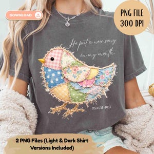 May include: Dark gray t-shirt featuring a colorful patchwork bird design. The bird has a pink gingham head, floral wings, and a yellow beak. Text on the shirt reads "He put a new song in my mouth" and "PSALM 40:3".