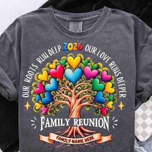 May include: Dark gray t-shirt with a colorful tree design. The tree's leaves are heart-shaped in various colors. Text includes "OUR ROOTS RUN DEEP", "OUR LOVE RUNS DEEPER", "2026", and "FAMILY REUNION". A banner reads "FAMILY NAME HERE".