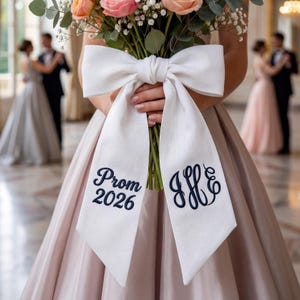 May include: A white ceramic cat figurine with a whimsical design. The cat has a long tail and is decorated with black spots and a smiling face. The figurine is approximately 6 inches tall.