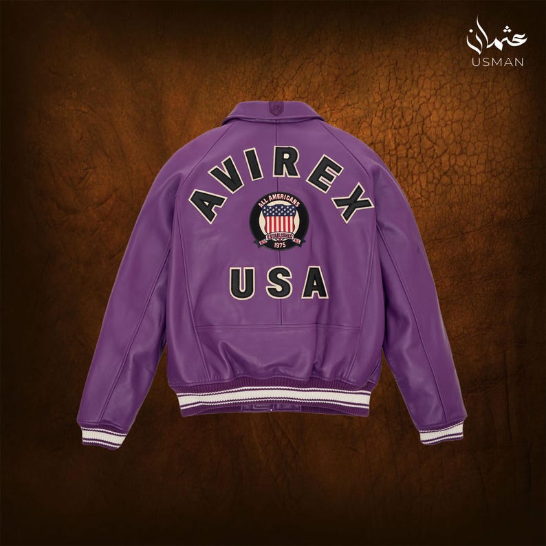 May include: A purple leather jacket with the word "AVIREX" arched across the back, above a circular patch with the American flag and the text "ALL AMERICANS 1975". The word "USA" is below the patch. The jacket has white and black striped cuffs.