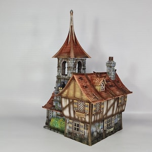 May include: A detailed miniature model of a medieval building, featuring a tall tower with a copper-coloured pointed roof and a lower structure with a red-tiled roof. The walls are painted in shades of brown and beige, with stone detailing. The model has a chimney.