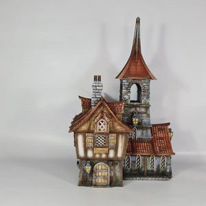 May include: A detailed miniature building with a steeple and a red-tiled roof. The structure features multiple windows, a stone facade, and a wooden door. The building has a whimsical, fairytale-like design, with a chimney and decorative lanterns.
