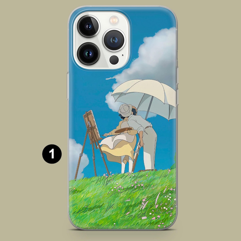 May include: A phone case featuring a scene of two people painting outdoors under a parasol. The artwork depicts a sunny day with a blue sky, white clouds, and a green grassy hill. The case has a clear border.