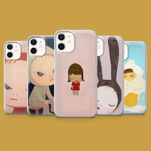 May include: A collection of phone cases featuring whimsical illustrations. The cases showcase various designs, including a girl in a red dress, a bunny, and other cartoon characters. The cases are displayed against a mustard-colored background.