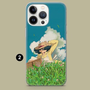 May include: A phone case featuring a cartoon illustration of a person in a yellow dress and straw hat, set in a field of tall green grass and flowers. The background shows a blue sky with white clouds.