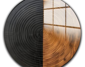May include: A round wooden wall art piece, split in half. One side is stained black, displaying concentric circles. The other side is natural wood, with a window reflection. The artwork is a decorative home accent.