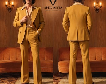 May include: A mustard yellow suit featuring a blazer with wide lapels and flared trousers. The ensemble is paired with a patterned button-down shirt. The text APEX SUITS FORMAL SUITS FOR MAN is displayed above the suit in a dark font.