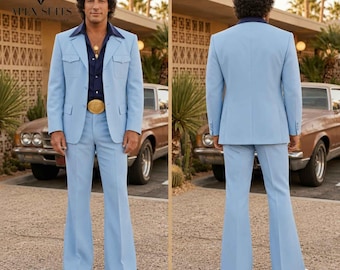 May include: A light blue suit featuring a jacket with two chest pockets and matching flared trousers. The ensemble is worn with a dark navy blue button-down shirt, a gold-toned belt buckle, and white shoes, shown from both front and back views.