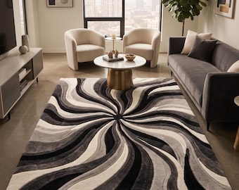 Hand tufted abstract swirl rug in black, gray, and ivory, designed to bring modern texture and artistic movement to your space,