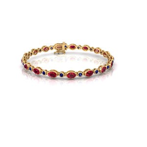 May include: A gold bracelet with alternating red and blue gemstones. The bracelet has an oval-cut design with a secure clasp. The gemstones are set in a gold band, creating a repeating pattern. The gemstones are evenly spaced.