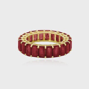 May include: A gold ring with a continuous band of rectangular, deep red gemstones. The gemstones are set closely together, creating a full circle of colour. The ring is displayed on a light background.