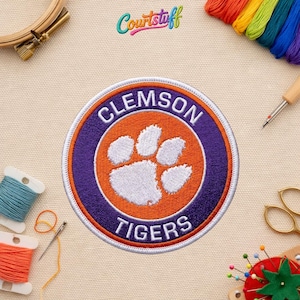 May include: A white ceramic mug with a black handle and the text "But First, Coffee" in a handwritten style. The mug is likely for hot beverages and has a glossy finish.