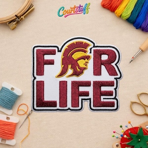May include: Embroidered patch with the words "FOR LIFE" in maroon block letters. The patch features a gold and maroon Trojan warrior helmet design. The patch is surrounded by a black border. The word "Courtstuff" is in the upper right corner.