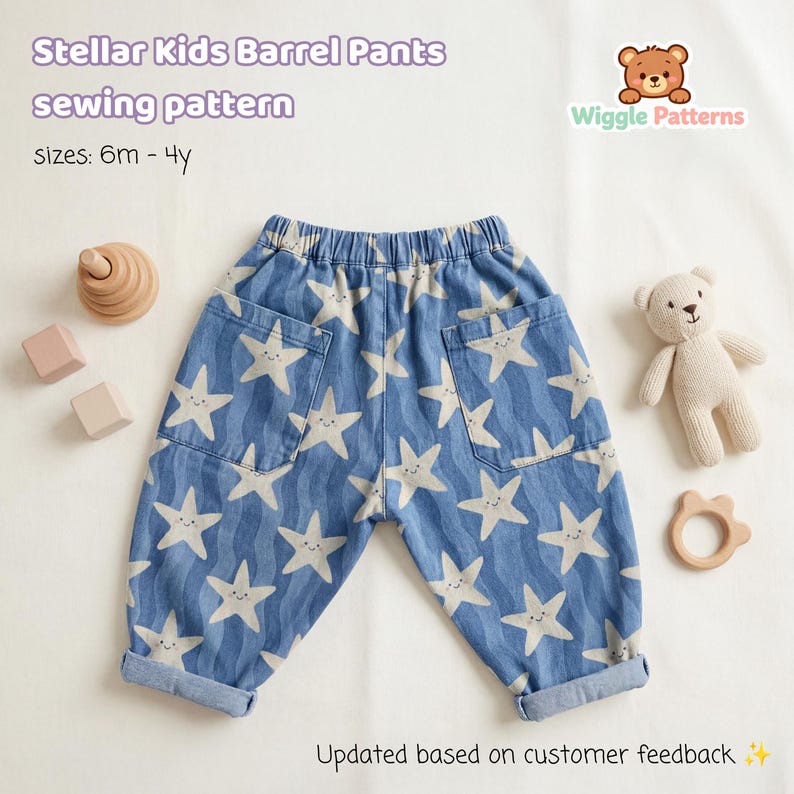 May include: Blue barrel pants with a white star pattern, featuring two front pockets. The text "Stellar Kids Barrel Pants sewing pattern" is visible. The pants are designed for sizes 6 months to 4 years. A teddy bear and wooden toys are also in the image.