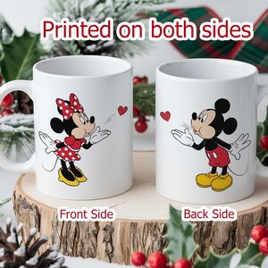 Matching white ceramic couple mugs featuring a Disney cartoon mouse boy and girl (Mickey and Minnie) facing each other with hearts.