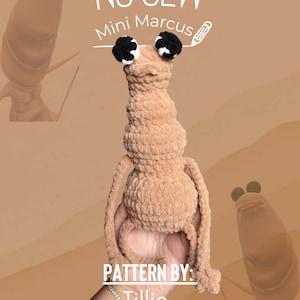 May include: A tan, no-sew crochet Mini Marcus doll with black and white eyes. The doll is held in a hand. Text on the image reads "NO SEW Mini Marcus" and "PATTERN BY: Tillie @Tillies_specialdesigns."