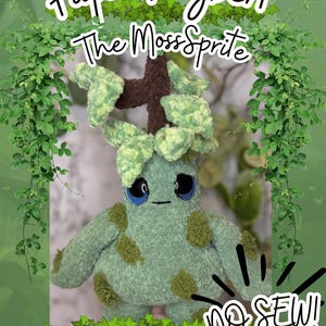 May include: A handmade plush toy of Papa Twigbert, The Moss Sprite, in shades of green and brown. The plush has large blue eyes and a cross-shaped head. The text "NO SEW!" is visible. The background is a green gradient with leafy vines.