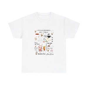May include: White t-shirt featuring a tea-themed design with teacups, teapots, and the text "POWERED BY TEA." The graphic also includes "Tea & Biscuits," "Fruit Tea," and "Bubble Tea." The shirt is a casual wear item.