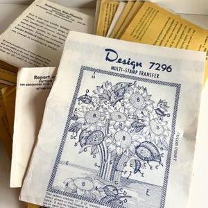 May include: A vintage craft pattern for a multi-stamp transfer design featuring a cluster of sunflowers. The pattern is labeled "Design 7296" and includes a color chart.