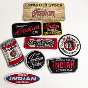 May include: A selection of embroidered patches showcasing the "Indian Motorcycle" brand. The patches feature diverse designs, including the brand name, logos, and phrases such as "Extra Old Stock" and "Big Chief". The colour palette includes red, black, white, and yellow.