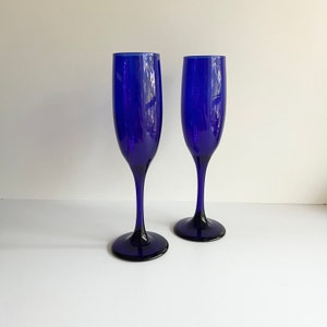 May include: Two cobalt blue glass champagne flutes.