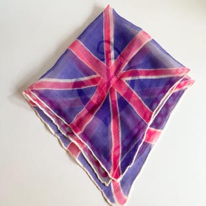 May include: A pink and purple silk scarf with a Union Jack design.