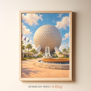 May include: A framed art print featuring a large, white, geodesic sphere structure under a bright blue sky with scattered clouds. The scene includes a circular fountain in the foreground, palm trees, and several flags on poles. The text reads SKYWARD ART PRINTS | ON Etsy.