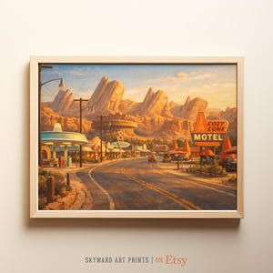 May include: A framed print depicting a desert town with a road leading to mountains. The image includes a sign for the "Cozy Cone Motel". The sky is a blend of blue and orange, possibly indicating dawn or dusk. The print is in a wooden frame.