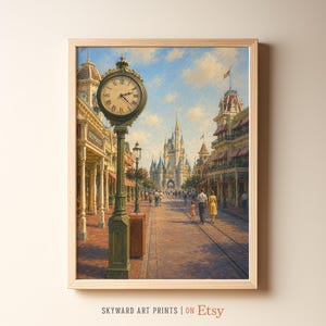 May include: A framed art print depicting a street scene with a large ornate clock on a green post in the foreground. A tall castle stands in the distance at the end of a brick path lined with multi-story buildings under a blue sky with clouds.