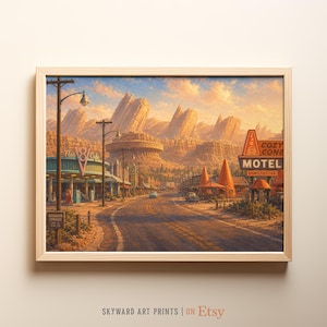 May include: A framed art print depicting a desert town scene with a road leading toward rocky mountains. The image features a Flo's V8 Cafe sign, a Cozy Cone Motel sign, and a Radiator Springs sign under a warm, golden sunset sky.