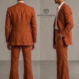 May include: A rust-colored suit with a tailored jacket and flared pants. The suit is worn with a white dress shirt. The image includes the text "MATTY FASHION TUXEDO SHOP".