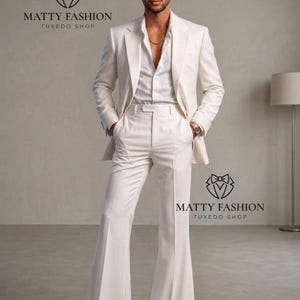May include: A man in a white suit with a matching jacket and flared pants. The suit is paired with a white dress shirt and black dress shoes. The image includes the text "MATTY FASHION TUXEDO SHOP".