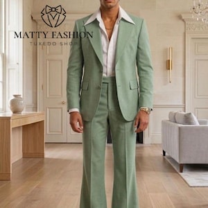 May include: A light green suit with a wide lapel jacket and flared pants. The suit is paired with a white dress shirt. The image includes the text "MATTY FASHION TUXEDO SHOP".