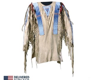 May include: A tan leather jacket featuring long fringe along the sleeves and chest. The garment is decorated with blue, white, and red beaded geometric patterns, including a central triangular motif on the chest and vertical bands on the shoulders.