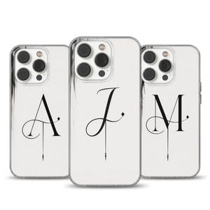 May include: Three clear phone cases with white marble-like backgrounds. Each case features a different black initial: A, J, and M, in an elegant, stylized font. The cases are designed for a smartphone.