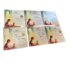 May include: A collection of six Newbery Award winning children's books. The books are all hardcover and feature illustrations on the covers. The titles of the books are "Up a Road Slowly", "Gay-Ned: The Story of a Pioneer", "Amos Fortune, Free Man", "Across Five Aprils", "The Voyages of Doctor Dolittle", and "The Story of a Pioneer".