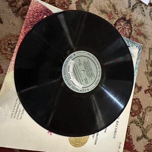 May include: A black vinyl record with a white label that reads "NEWSTREET" "SPECIAL RECORD" "MILLER" "HIGH SCHOOL" "RECORDING INC."