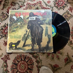 May include: A vintage vinyl record of "Rip Van Winkle" read by Ed Begley. The cover art depicts a man walking through a woodland with a gun and a dog.