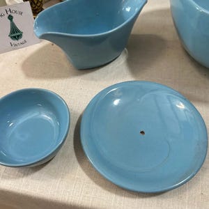 May include: A collection of vintage light blue ceramic serving dishes. The set includes a bowl, a saucer, and a gravy boat. The Fig House Vintage logo is visible in the background.
