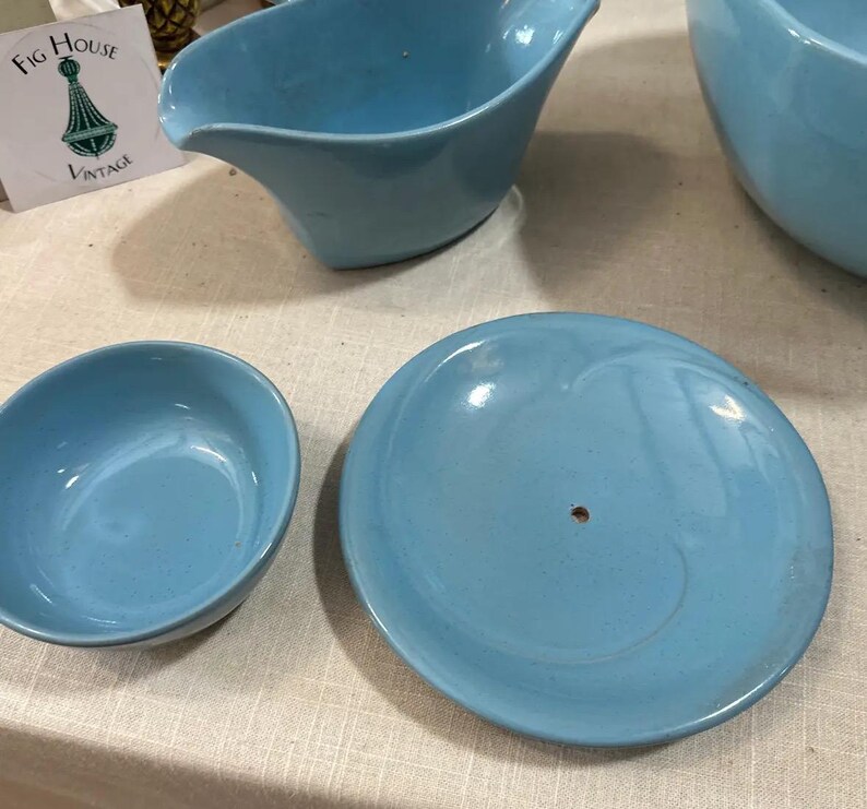 May include: A collection of vintage light blue ceramic serving dishes. The set includes a bowl, a saucer, and a gravy boat. The Fig House Vintage logo is visible in the background.