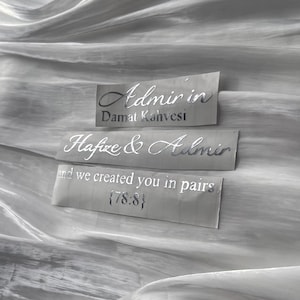 May include: Three rectangular labels with silver text on a grey background. The top label reads "Admir in Damat Kahvesi." The middle label says "Hafize & Admir." The bottom label reads "and we created you in pairs {78:8}."