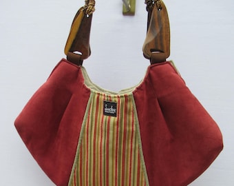 Hand made fabric purse, red suede like fabric and khaki red and yellow stripes  upholstery, top handled, wooden handles