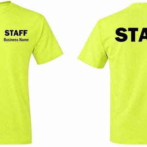 May include: Bright yellow t-shirts with the word "STAFF" printed in bold black letters on the front and back. The front of the shirt also has the text "STAFF" and "Business Name" in black. The shirts are short-sleeved.