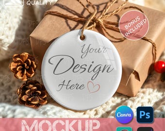 May include: A white ceramic ornament with the text "Your Design Here" and a heart graphic, hanging in front of a wrapped gift box. The image includes pinecones and the words "Bonus Included".