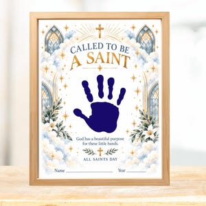 May include: A framed print featuring the text CALLED TO BE A SAINT, a dark blue handprint in the center, and the text God has a beautiful purpose for these little hands. ALL SAINTS DAY, Name, and Year are printed at the bottom.