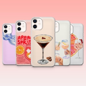 May include: A collection of phone cases featuring watercolor illustrations of cocktails. The cases showcase various drinks, including a martini with coffee beans, Aperol Spritz, and other mixed drinks. The cases have a pink background.