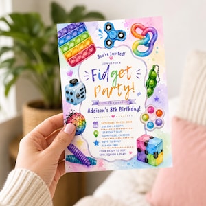 May include: A rectangular birthday invitation card featuring watercolor illustrations of various fidget toys including a pop-it, spinner, and cube. The text reads: You're Invited! Join us for a Fidget Party! to celebrate Addison's 8th Birthday!