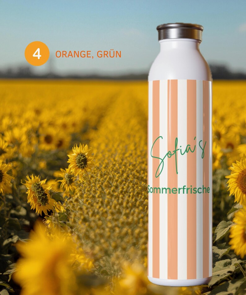 May include: A white water bottle featuring vertical orange and white stripes. The text "Sofia's" is written in a green cursive script above the green printed word "Sommerfrische". The bottle has a metallic silver cap and a smooth cylindrical body.