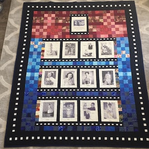 May include: A blue and red quilt with a black border and a film strip design. The quilt features black and white photos of people in various poses. The quilt is made of squares of fabric and has a patchwork design.